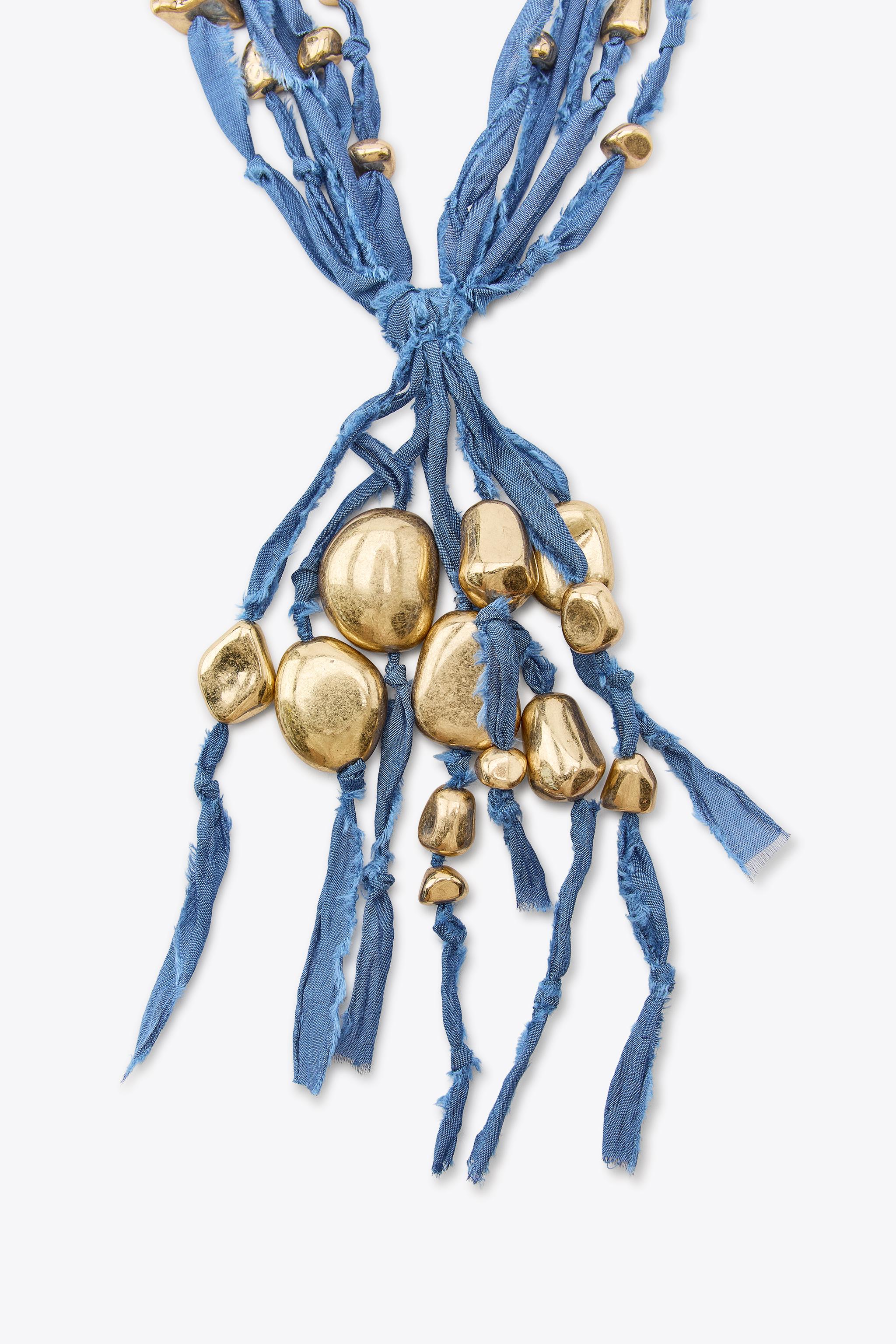 WOVEN NECKLACE WITH METAL PIECES